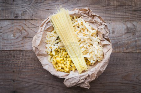 Photo for Abstract background ingredients for making pasta with various pasta on a wooden rustic table. Italian food - Royalty Free Image