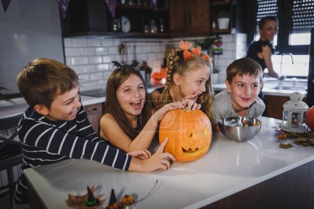 Photo for Happy halloween. family in kitchen, having fun - Royalty Free Image