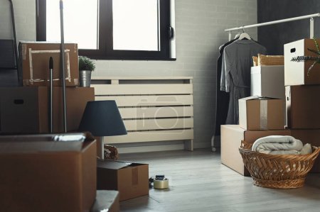 Photo for Interior of a new apartment room with a lot of boxes - Royalty Free Image