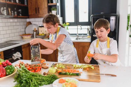 Photo for Two kids cooking salad in the kitchen - Royalty Free Image