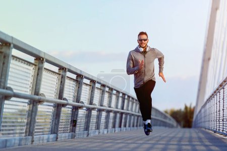 Photo for Young fit fitness man jogging on a city street. healthy lifestyle - Royalty Free Image