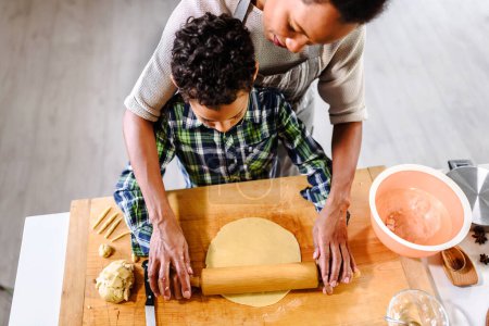 Photo for African american mother and son preparing pumpkin pie - Royalty Free Image