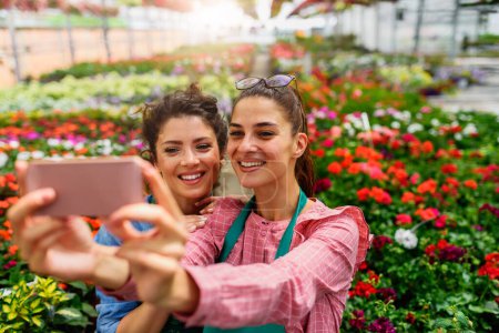 Photo for Beautiful women gardeners making selfie - Royalty Free Image