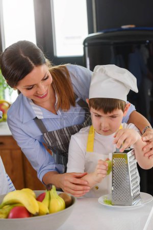 Photo for Mother and son cooking together - Royalty Free Image