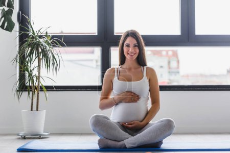 Photo for Pregnant woman exercising at the gym - Royalty Free Image