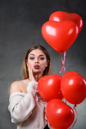 Photo for Beautiful young woman with bunch of red heart balloons. Valentines day - Royalty Free Image