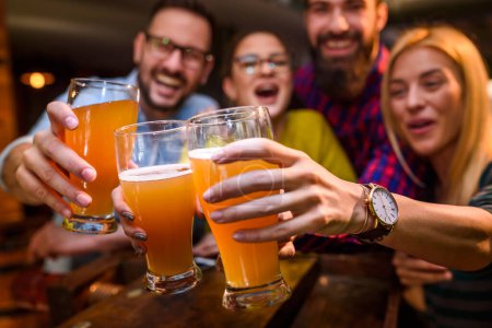 Photo for Group of friends drinking beer in pub - Royalty Free Image