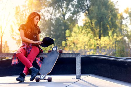 Photo for Cute urban girl with longboard in skate park - Royalty Free Image
