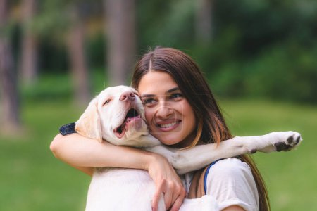 Photo for Young woman with her dog in the park - Royalty Free Image