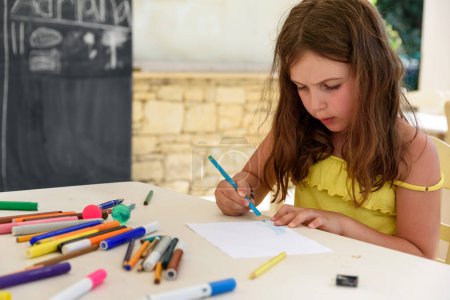 Photo for Little girl drawing with crayons at home - Royalty Free Image