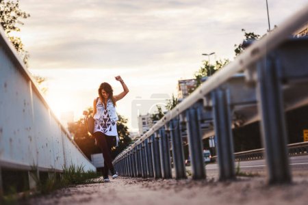Téléchargez les photos : Mignonne fille urbaine tenant longboard dans skate park - en image libre de droit