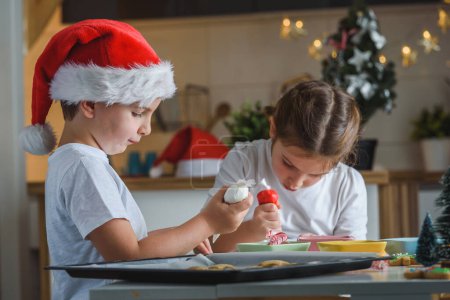 Téléchargez les photos : Petit garçon et fille préparant des biscuits de pain d'épice de Noël - en image libre de droit
