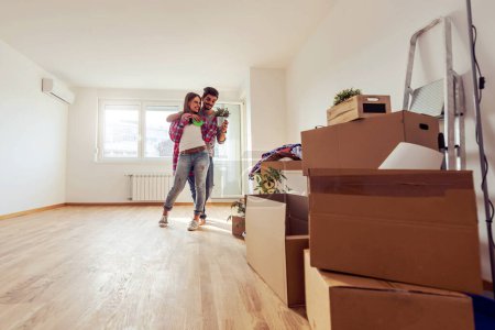 Photo for Young couple moving in the new apartment - Royalty Free Image