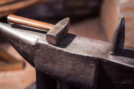 Photo for Blacksmith's hammer and anvil in old workshop close up - Royalty Free Image