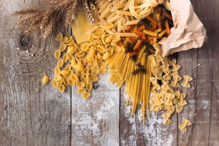 Photo for Various mix of pasta on wooden rustic background - Royalty Free Image