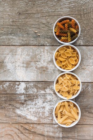 Photo for Various mix of pasta on wooden rustic background - Royalty Free Image