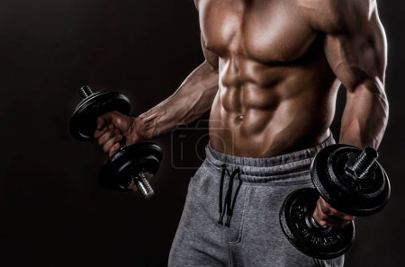 Photo for Muscular man with naked torso holding dumbbells, isolated on black background - Royalty Free Image