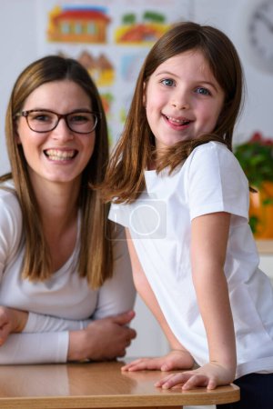 Téléchargez les photos : Portrait de maternelle professeur avec fille mignonne - en image libre de droit