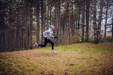 Photo for Young man running in forest. active lifestyle - Royalty Free Image