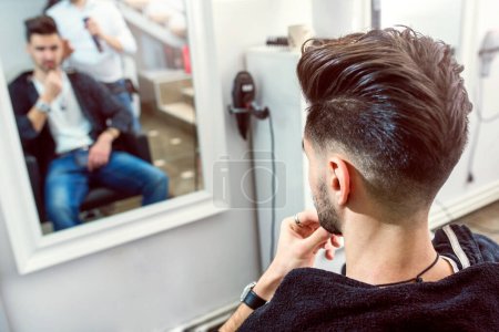 Photo for Man having his hair trimmed in hairdressing salon - Royalty Free Image