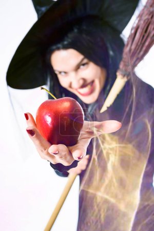 Photo for Evil Beautiful Witch With Poisoned Apple - Royalty Free Image