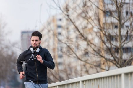 Photo for Young man jogging in the city - Royalty Free Image