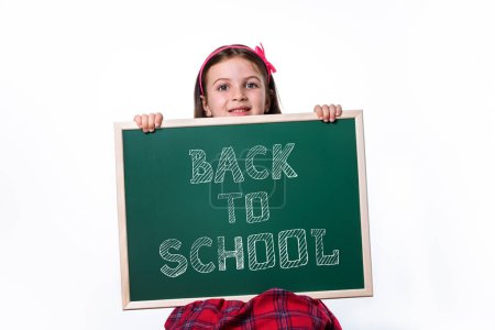 Photo for Little School Girl Holding Green Chalkboard With Back to School Sign - Royalty Free Image