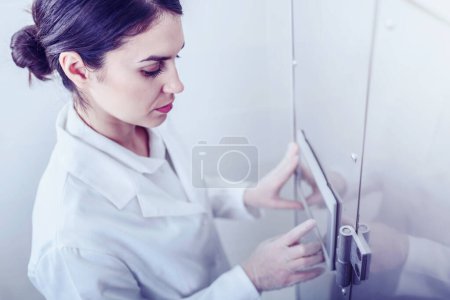 Photo for Woman Scientist in Facility Typing on Control Panel - Royalty Free Image