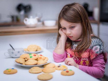 Téléchargez les photos : Petite fille souriante avec des biscuits - en image libre de droit