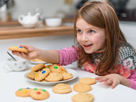 Photo for Smiling little girl with cookies - Royalty Free Image