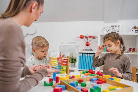 Photo for Cheerful children playing with colorful didactic toys in a Kindergarten. Play with educational toys. Learning through play. - Royalty Free Image