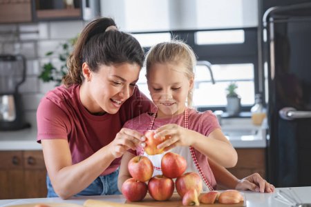Photo for Mother and daughter making pyramid with apples - Royalty Free Image
