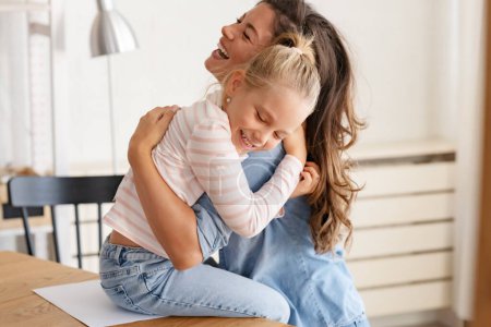 Photo for Mother and daughter at home hugging - Royalty Free Image