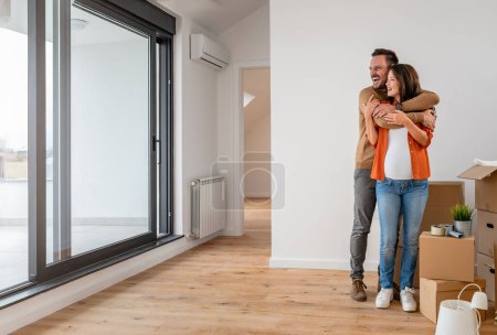 Photo for Young happy couple moving into new home. - Royalty Free Image
