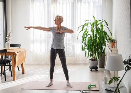 Photo for Senior woman exercising at home - Royalty Free Image
