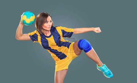 Photo for Female handball player with a ball on the field - Royalty Free Image