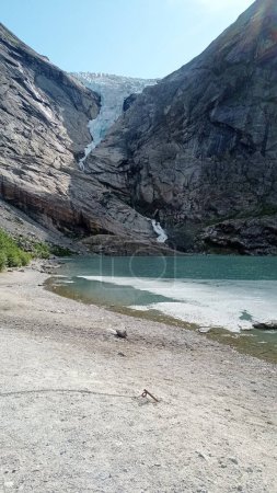 Briksdalsbreen Glacier in Olden, Nordfjord, Norway. The lake formed as a result of the melting of a glacier.