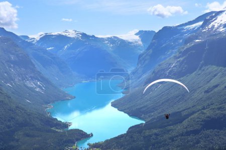 Photo for Panorama view over Loen and the inner part of nordfjord and flight of paraglider, Norway. Lovatnet lake from Leon skylift top in Norway. - Royalty Free Image