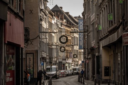 Photo for LIEGE, BELGIQUE - NOVEMBER 9, 2022: Rue du pont, a decaying street of the city center of Liege, with facade of old buildings ready to be renovated in a real estate operation. - Royalty Free Image
