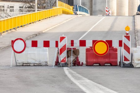 Photo for Selective blur on road barriers and no traffic signs, European standard, in front of a road being blocked for road repair and reconstruction in an urban environment - Royalty Free Image