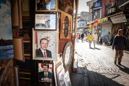 Photo for ISTANBUL, TURKEY - MAY 21, 2022: People passing by portraits of Turgut Ozal and Recep Tayyip Erdogan, current president of Turkey, in a street of Istanbul - Royalty Free Image