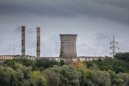 Photo for Selective blur on Arad power station, also called CET arad, seen from afar with its typical chimneys. It is a coal power plant, one of the main electricity producers in Romania.. - Royalty Free Image