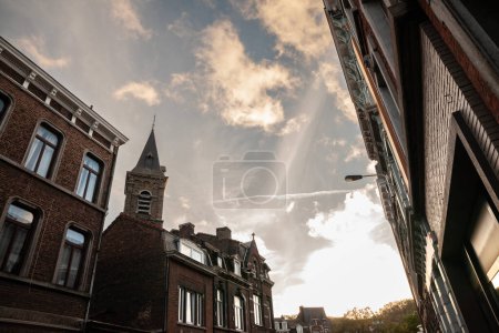Photo for Typical residential  street of the city center of Liege, Belgium, with facade of old buildings and a small catholic church at dusk. Liege, or Luik, is a Belgian Wallonia city. - Royalty Free Image
