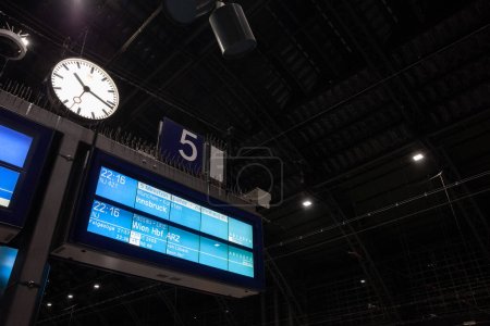 Photo for COLOGNE, GERMANY - NOVEMBER 8, 2022: Selective blur on a departures board of Koln Hauptbahnof cologne main railway station indicating a NightJet overnight train heading to Vienna (Wien) and Innsbruck. - Royalty Free Image