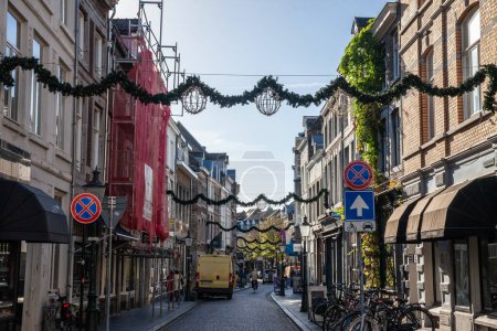 Photo for MAASTRICHT, NETHERLANDS - NOVEMBER 10, 2022: Panorama of Rechtstraat street in Maastricht city center, a pedestrian street surrounded by shops and stores with recently added christmas decorations. - Royalty Free Image