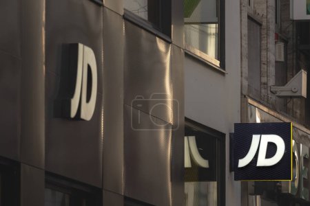 Photo for COLOGNE, GERMANY - NOVEMBER 10, 2022: Selective blur on a JD Sports logo on their store for Cologne. JD Sports is a british chain of fashion retailer specialized in sportswear clothing. - Royalty Free Image