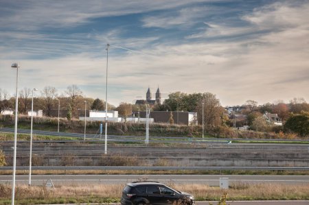 Photo for Panorama of a typical junction on a dutch motorway, with only a car driving near Maastricht in Limburg. Also called snelwegen, highways are a part of automobile infrastructure of netherlands. - Royalty Free Image