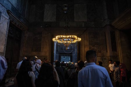 Photo for ISTANBUL, TURKEY - MAY 22, 2022: Selective blur on a crowd of tourists in the interior of of the AyaSofya camii mosque, also called haghia Sophia, a former orthodox church converted into a mosque. - Royalty Free Image