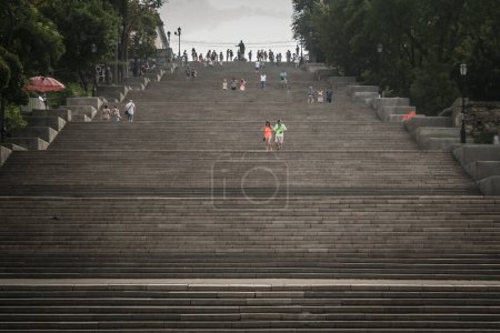 Photo for ODESSA, UKRAINE - AUGUST 6, 2014: Potemkin stairs with people descending them. The Odessa stairs, that got pictured in the famous Soviet movie Potemkin, are a major landmark of this Ukrainian city. - Royalty Free Image