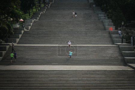 Photo for ODESSA, UKRAINE - AUGUST 6, 2014: Potemkin stairs with people descending them. The Odessa stairs, that got pictured in the famous Soviet movie Potemkin, are a major landmark of this Ukrainian city. - Royalty Free Image